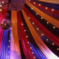 the 'ceiling' of a circus tent. a disco ball is to the left.