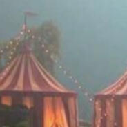 several small circus tents on a foggy day